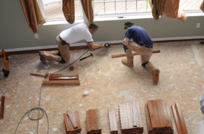 two men installing floor