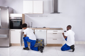 two adult staff remodeling the kitchen